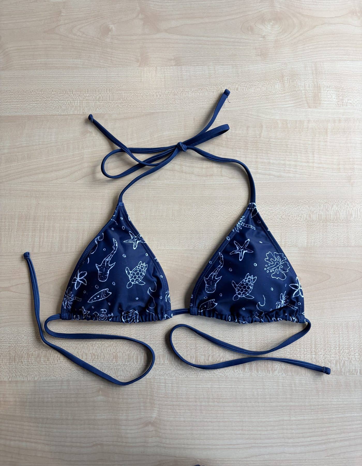 The Oceania bikini top, navy with a hand-drawn ocean print
